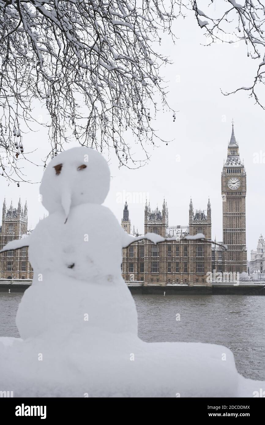 GREAT BRITAIN /England / London /A snowman on the banks of the River Thames opposite Houses of Parliament. Stock Photo