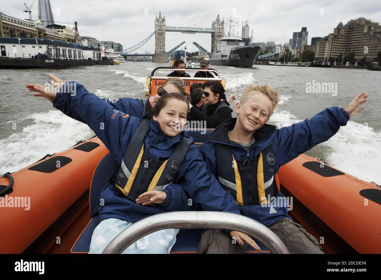 GREAT BRITAIN / England / London /Kids enjoy speed boat tour in the River Thames with Tower Bridge in the backround . Stock Photo