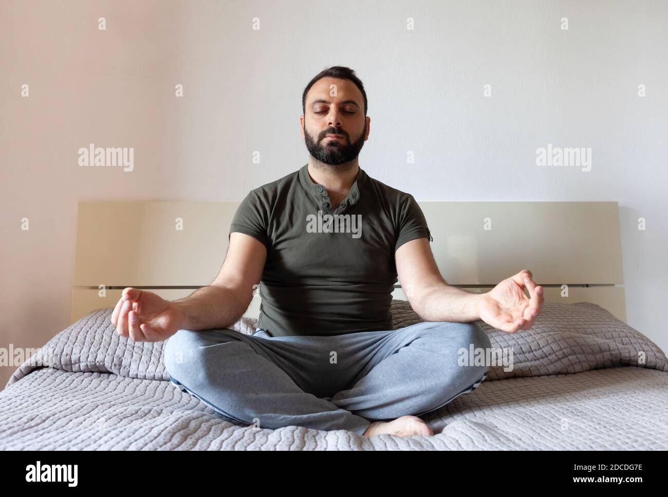 African Man Doing Yoga Online Meditating Sitting At Laptop Indoor