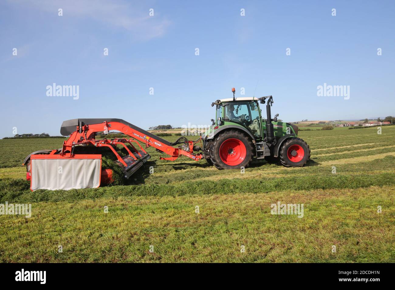 StrandHead Farm, Tarbolton, Ayrshire, Scotland 19 Sept 2020  Kuhn Merge Maxx raking machine in use turning over the grass Stock Photo