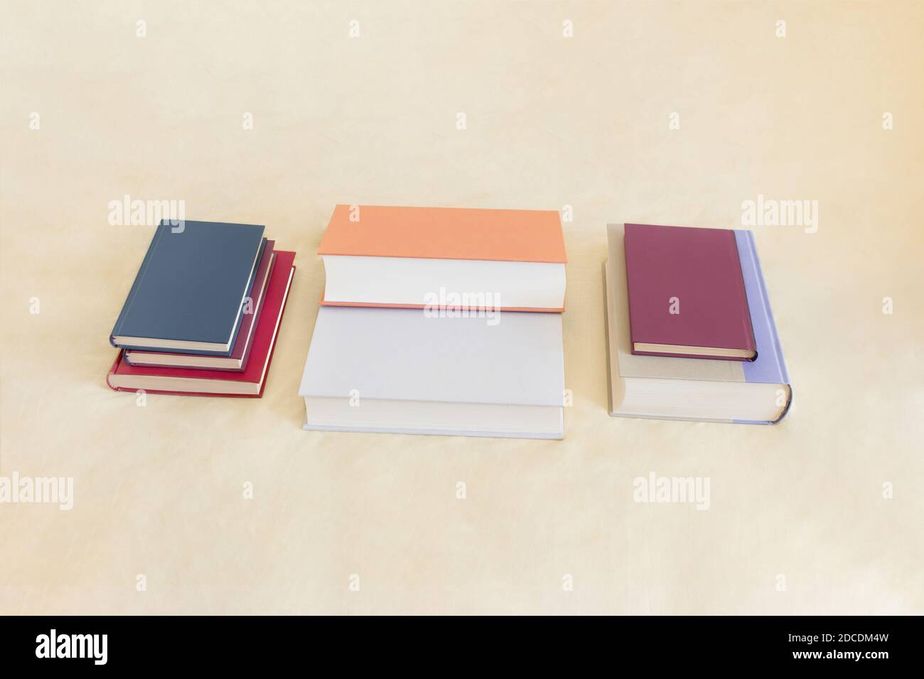 A group of different books of sizes and colors prepared for studying on a textured background. Learning and reading concept. Stock Photo