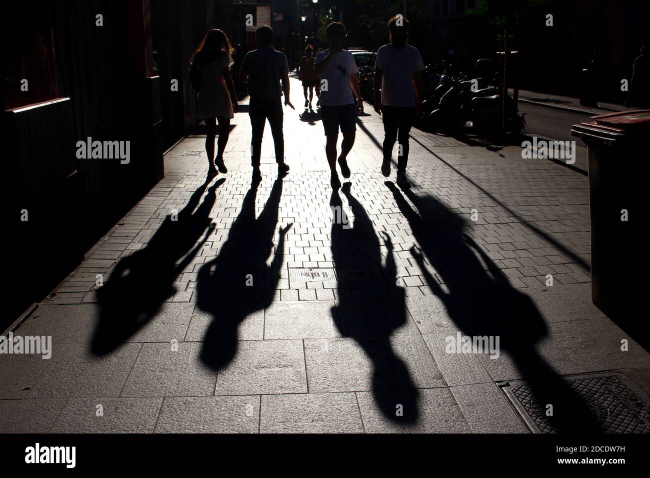 Shadows of people during sunset Stock Photo