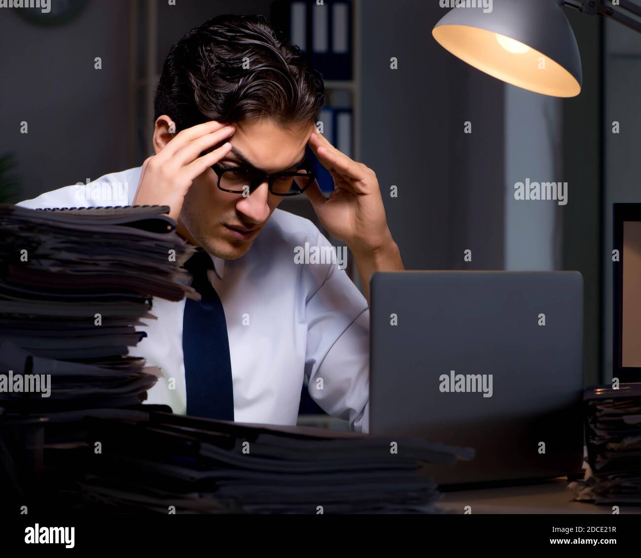 The young businessman working overtime late in office Stock Photo - Alamy