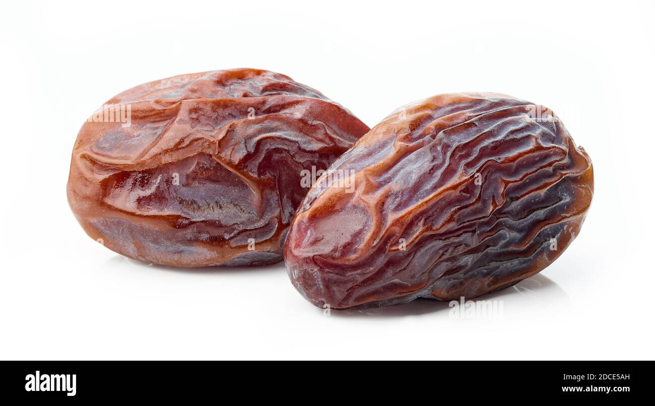 two juicy soft dried dates macro isolated on white background Stock Photo