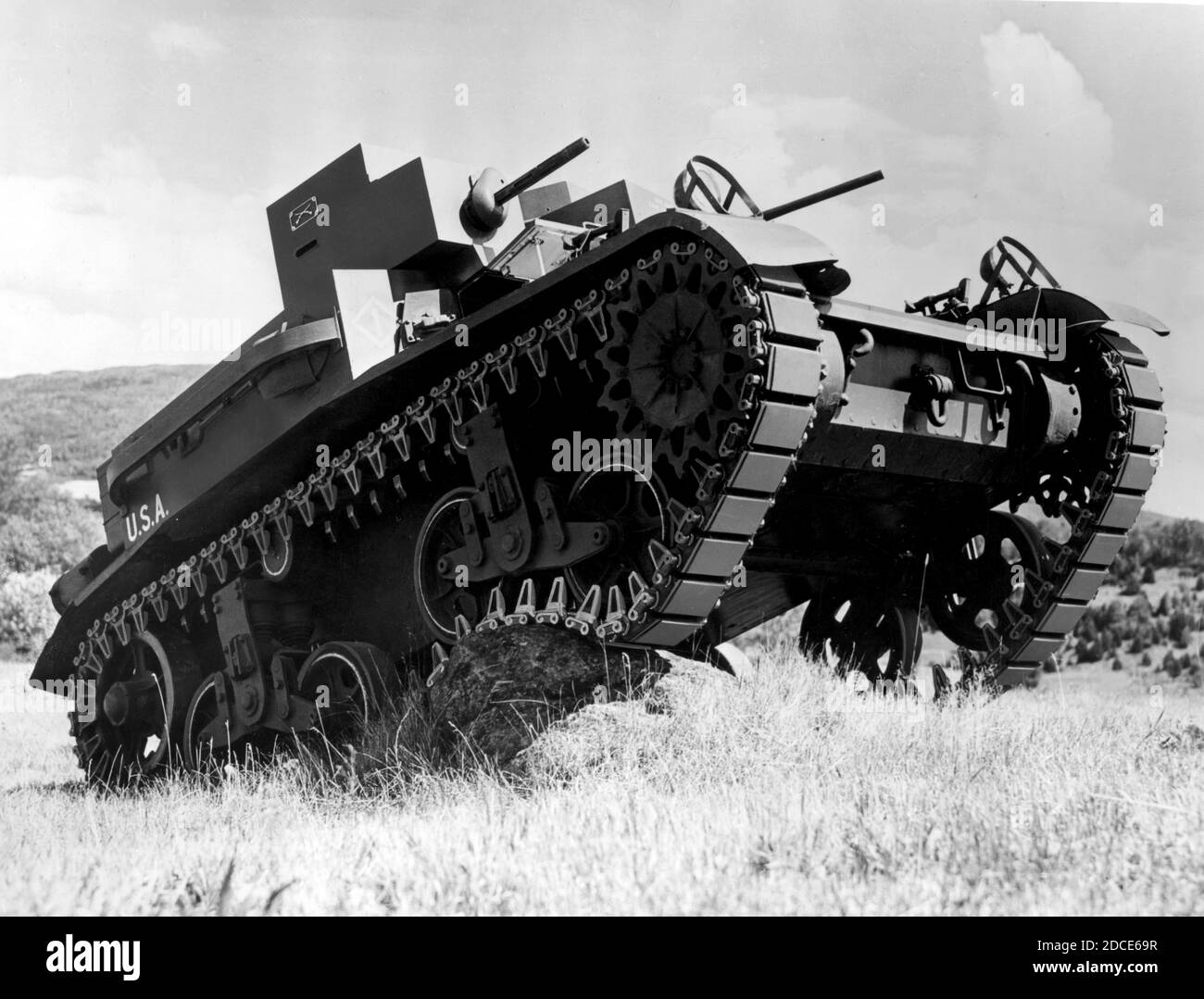 WW II - This is  'Light Tank, M2' being tested, about 1940. On the side of the turret is a pair of white, crossed swords, which designates that this tank belongs to the US Cavalry. These light tanks were produced in the United States before, and during the early years of, WW II. Due to their lighter weight and firepower, they were used in limited ways around the world during the war. They were generally armed with one 37 mm M5 gun and some .30 cal M1919 Browning machine guns. To see my other WW II-related images, Search:  Prestor  vintage  WW II Stock Photo