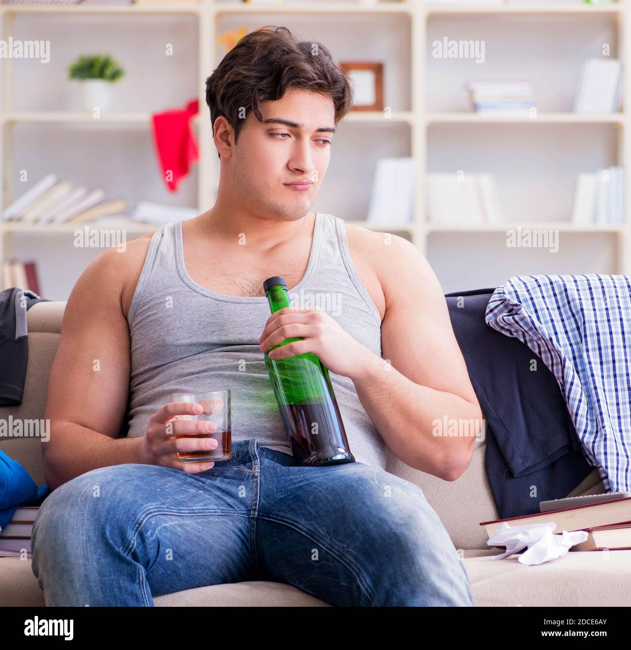 The young man student drunk drinking alcohol in a messy room Stock ...