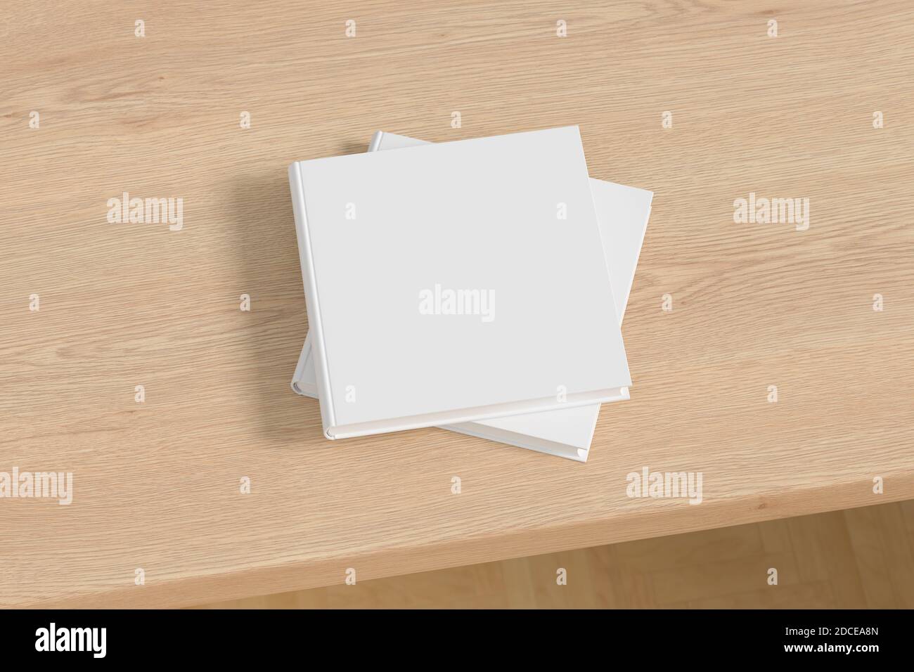Square white hardcover book stack mockup on the wooden table Stock Photo