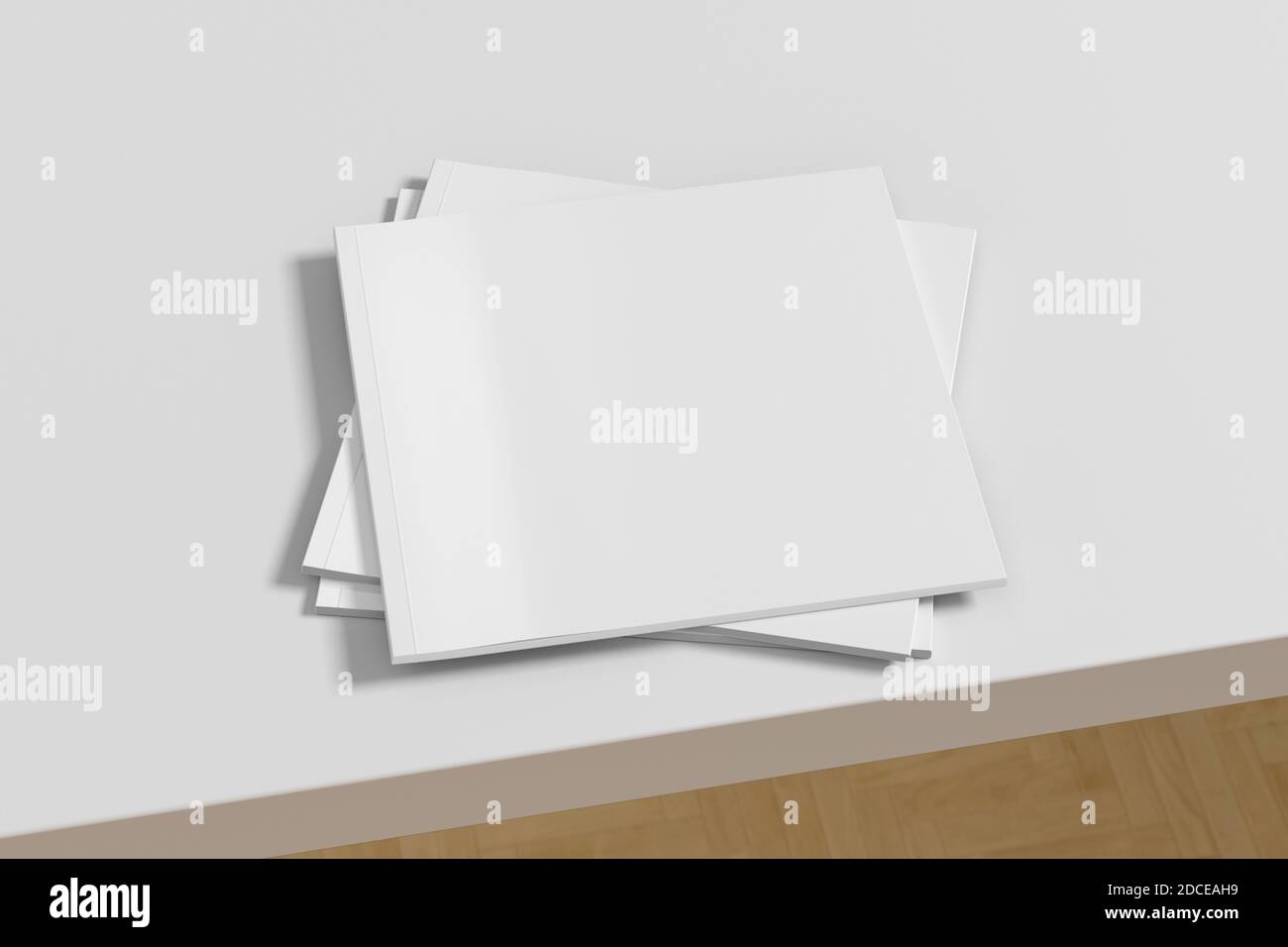 Square white magazine or brochure stack mockup on white table Stock Photo