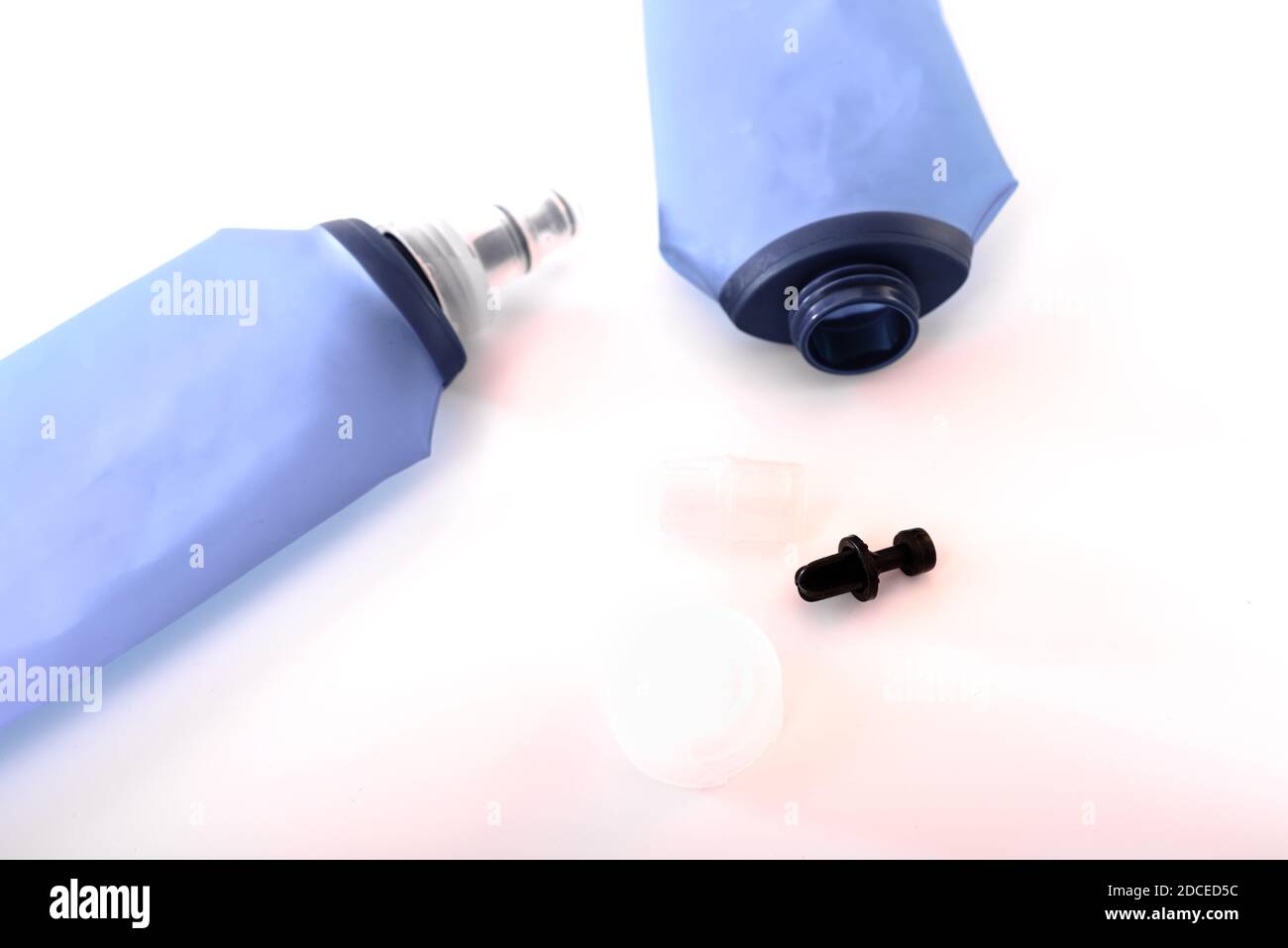 Blue plastic soft flasks, isolated on white background, must be cleaned