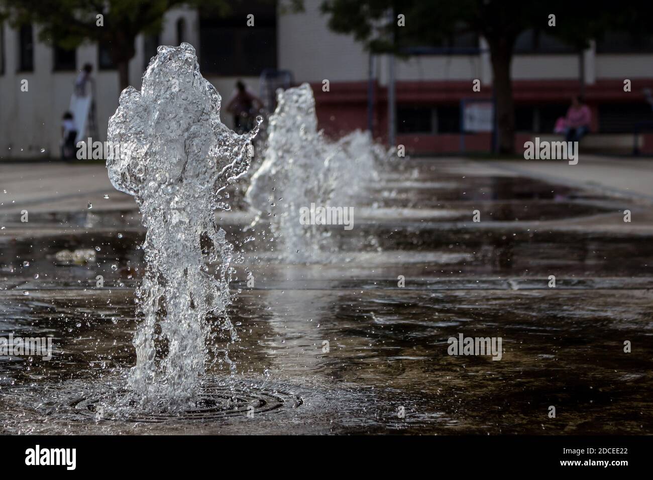 Small thick water jets of a park fountain in the town of Knjazevac, eastern Serbia. Fast shutter, water splash, close up. Stock Photo