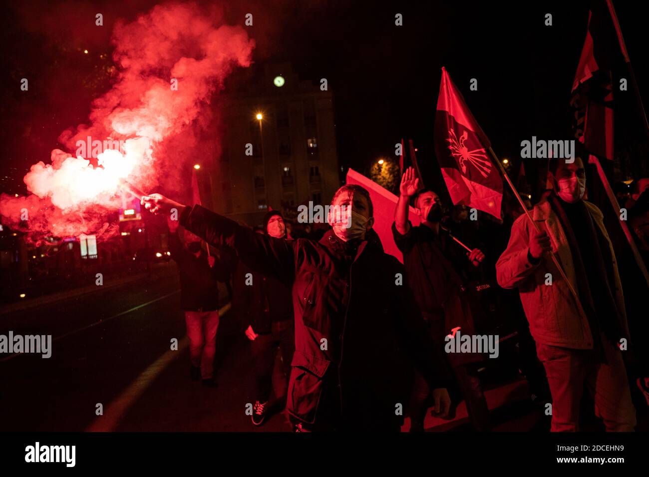 Madrid, Spain. 20th Nov, 2020. Far right wing supporter shouting slogans with a flare as others make a fascist salute during a rally to commemorate the death anniversary of Falange founder Jose Antonio Primo de Rivera. Credit: Marcos del Mazo/Alamy Live News Stock Photo