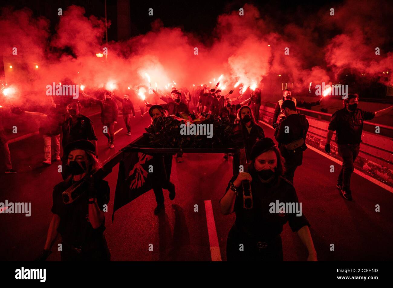 Madrid, Spain. 20th Nov, 2020. Far right wing supporters carrying a crown of flowers marching with flares during a rally to commemorate the death anniversary of Falange founder Jose Antonio Primo de Rivera. Credit: Marcos del Mazo/Alamy Live News Stock Photo