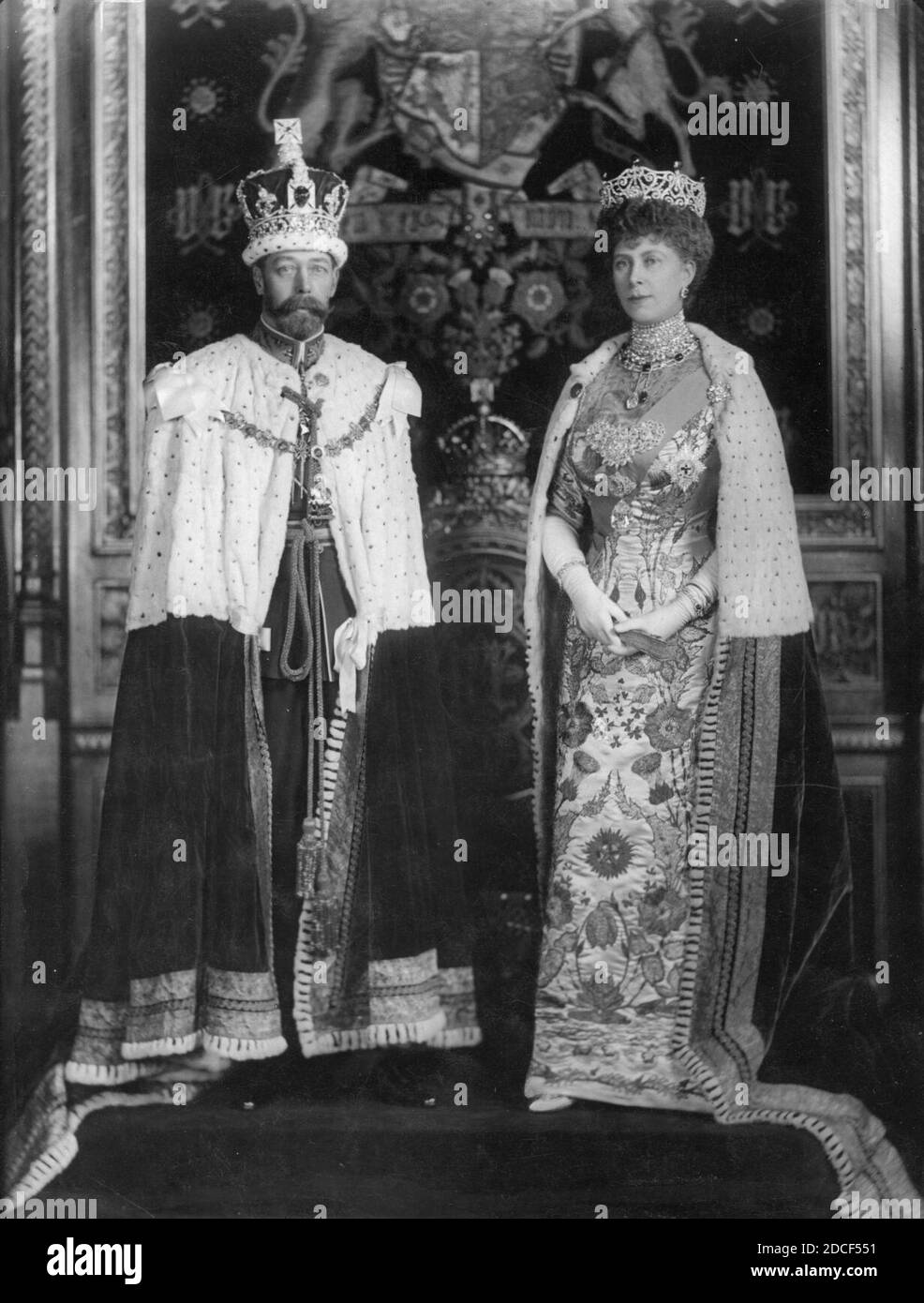 Debutantes, clad in their finery curtsey to King George V and Queen Mary  during a court presentation. Thus they are launched into  "Society". Date: 1928 - SuperStock