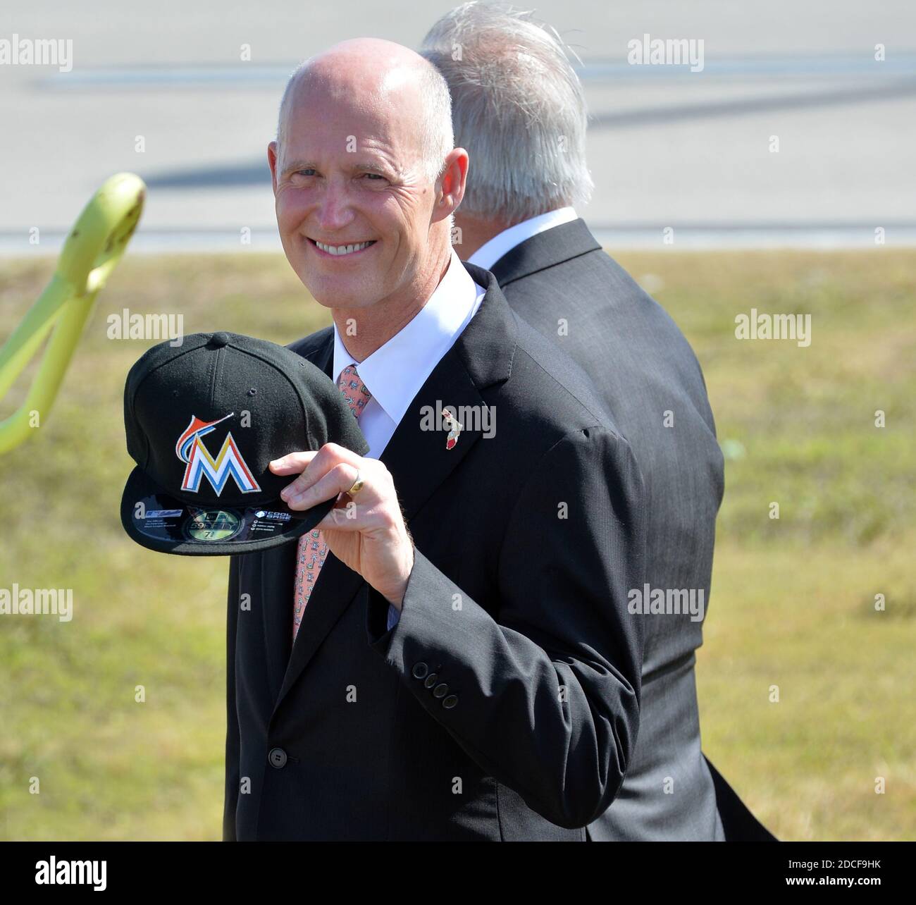 MIAMI, FL - FEBRUARY 25: Florida Governor Rick Scott greets U.S. President Barack Obama on Air Force One with a Florida Marlins cap at Miami International Airport on February 25, 2015 in Miami, Florida  People:  Florida Governor Rick Scott Credit: Hoo-me / MediaPunch Stock Photo
