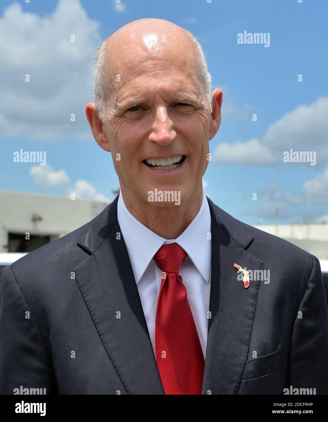 MIAMI, FL - FEBRUARY 25: Florida Governor Rick Scott greets U.S. President Barack Obama on Air Force One with a Florida Marlins cap at Miami International Airport on February 25, 2015 in Miami, Florida  People:  Florida Governor Rick Scott Credit: Hoo-me / MediaPunch Stock Photo