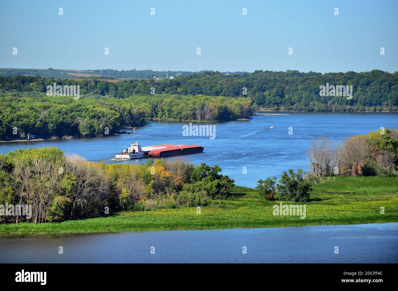 Tugboat pushing four barges in the Mississippi River
