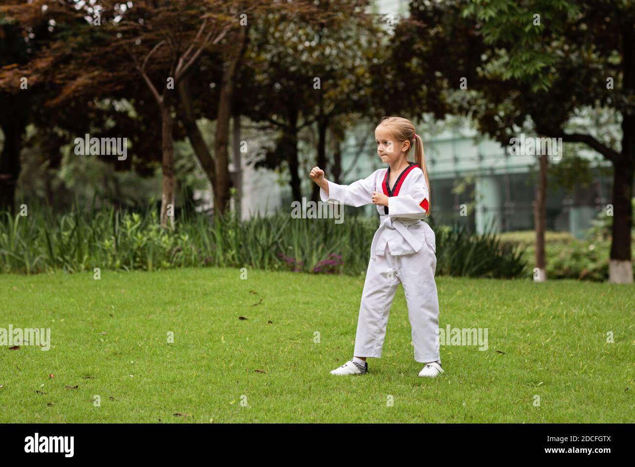 Caucasian little girl six years old in kimono with white belt