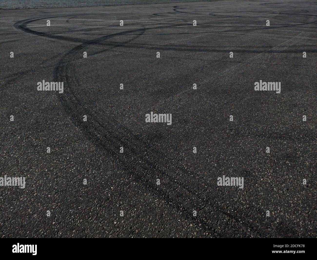 The concept of street racing and drifting on grey asphalt - car tire marks on the asphalt Stock Photo