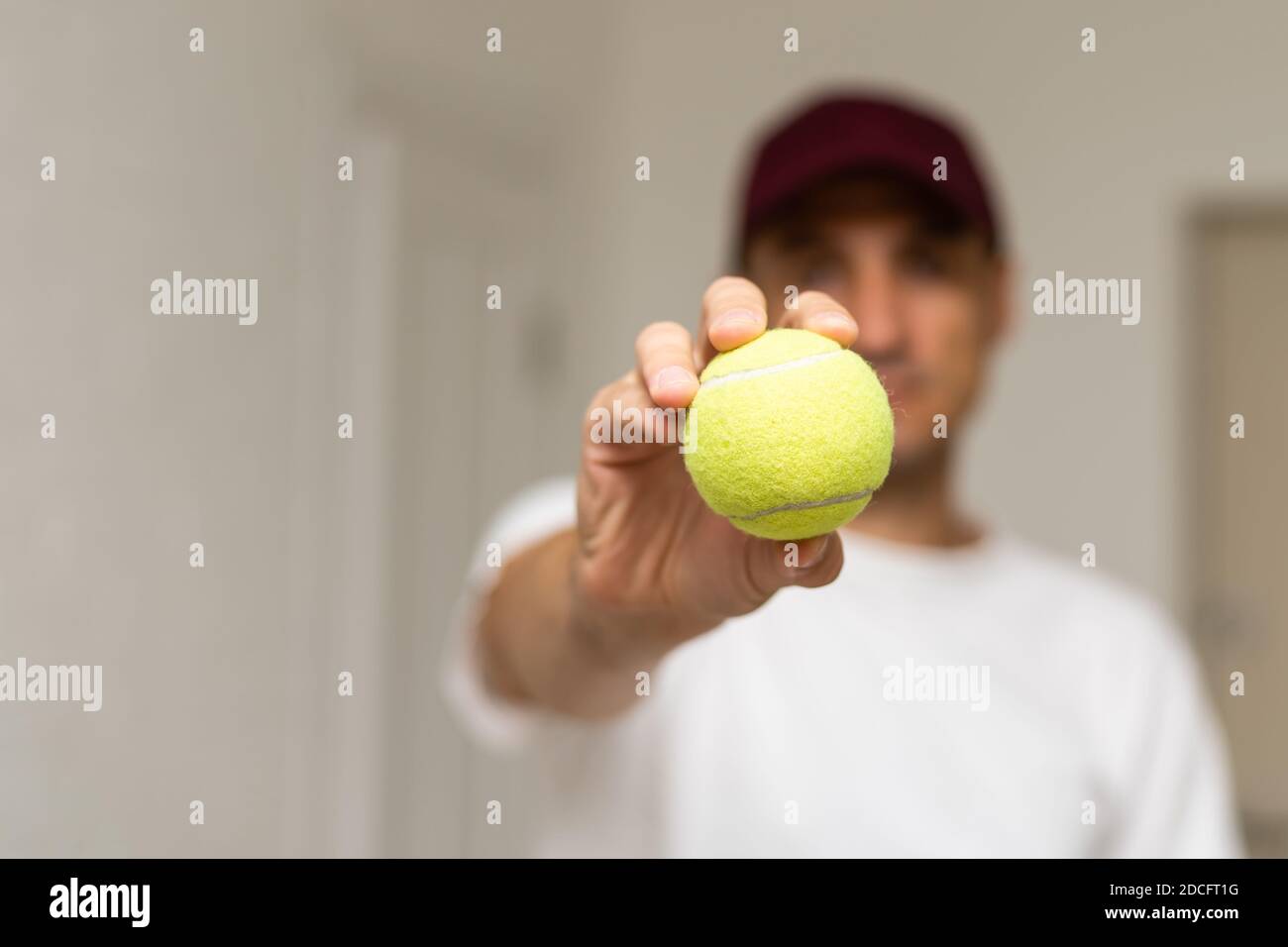 Close-up of male hand holding tennis ball and racket. Professional ...