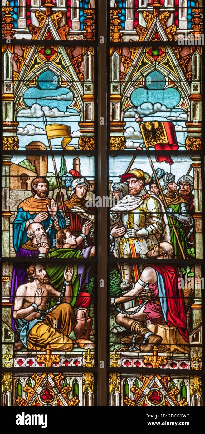 VIENNA, AUSTIRA - OCTOBER 22, 2020:  The liberation of christian prisoners in Tunisia  by Charles V on the stained glass in the Laurentiuskirche. Stock Photo