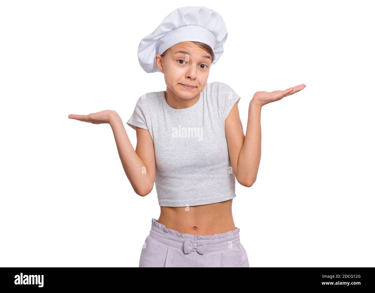 Teen girl in chef hat with emotions showing signs with hands, isolated on a white background. Stock Photo