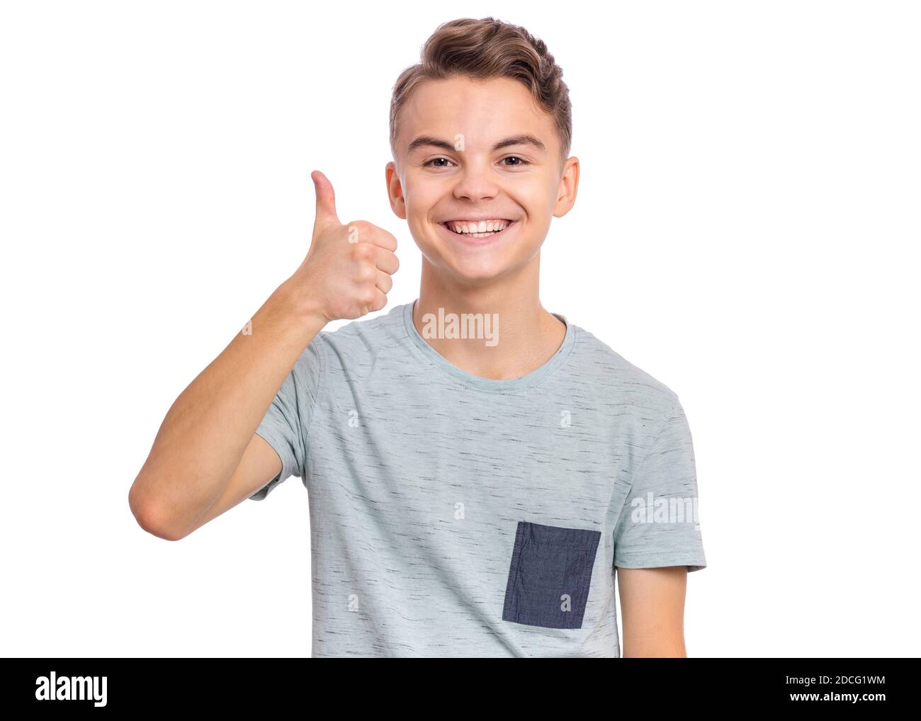 Cute teen boy pointing up, gesturing idea or doing number one gesture. Stock Photo