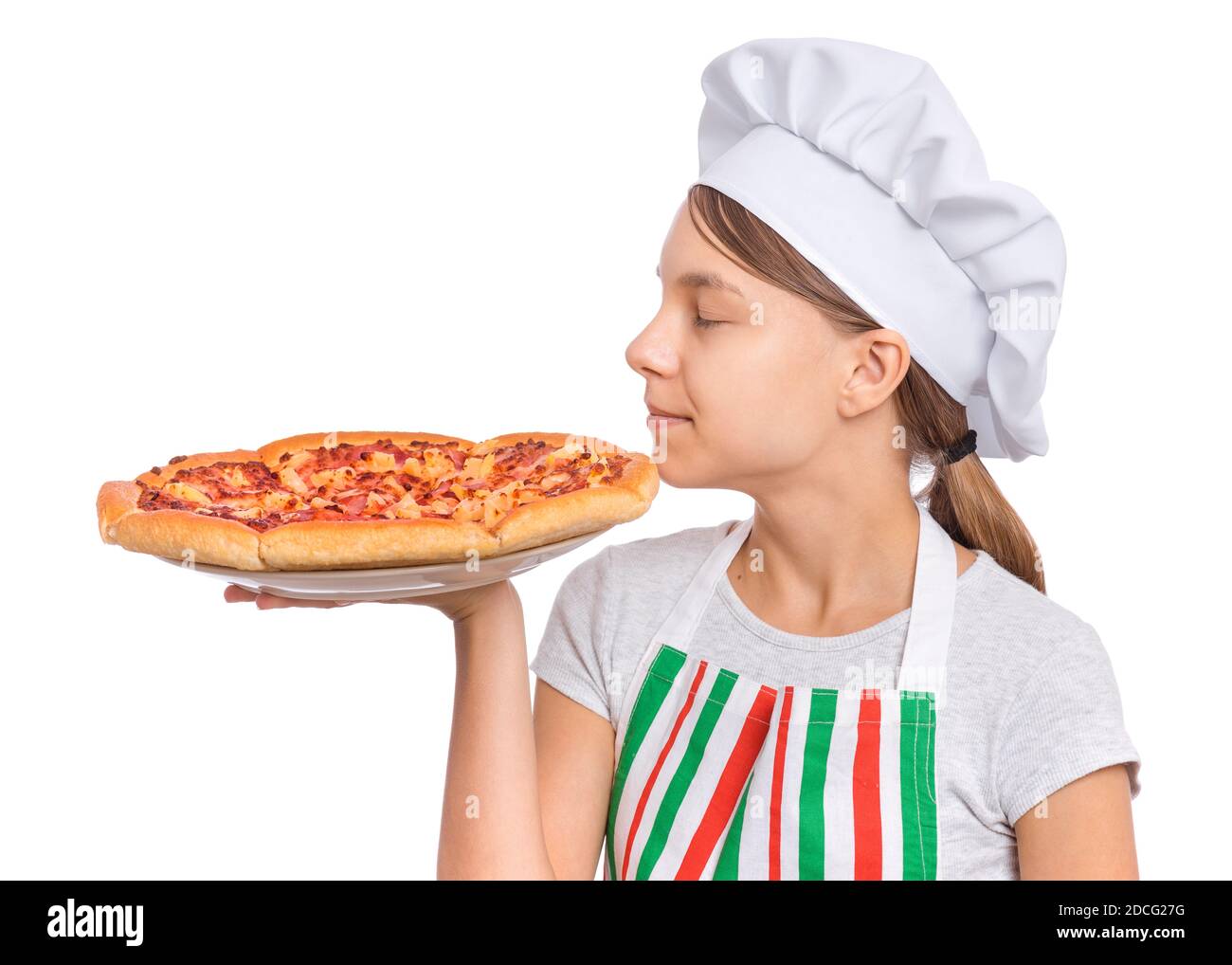 Girl cook in apron holds plate with fresh pizza, isolated on white background. Stock Photo