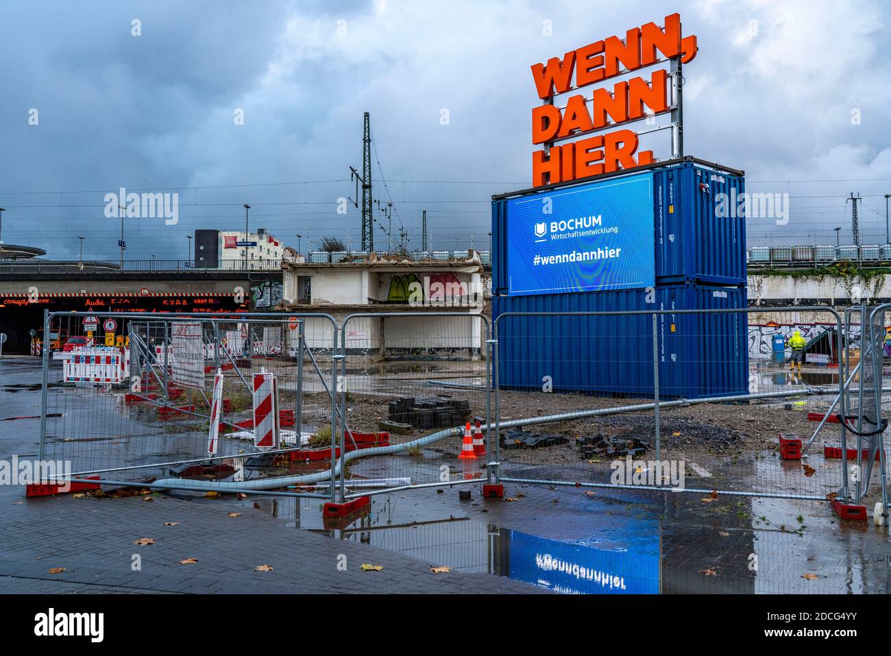 Main station ,Construction site for a new building, illuminated advertising, neon writing, digital billboard, billboard, for the Ruhr area, city adver Stock Photo