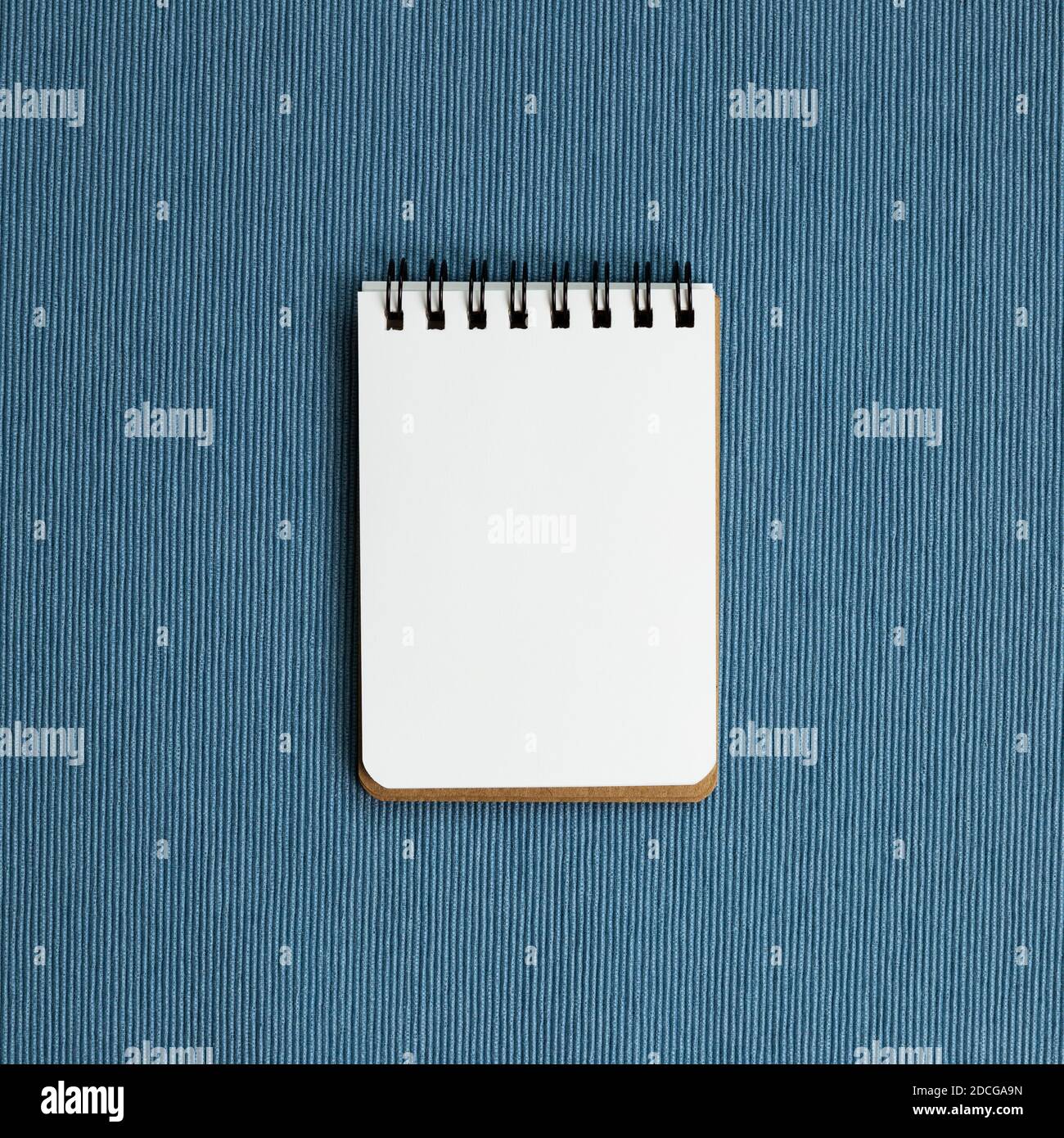 Empty notebook on blue fabric background. top view, copy space Stock Photo