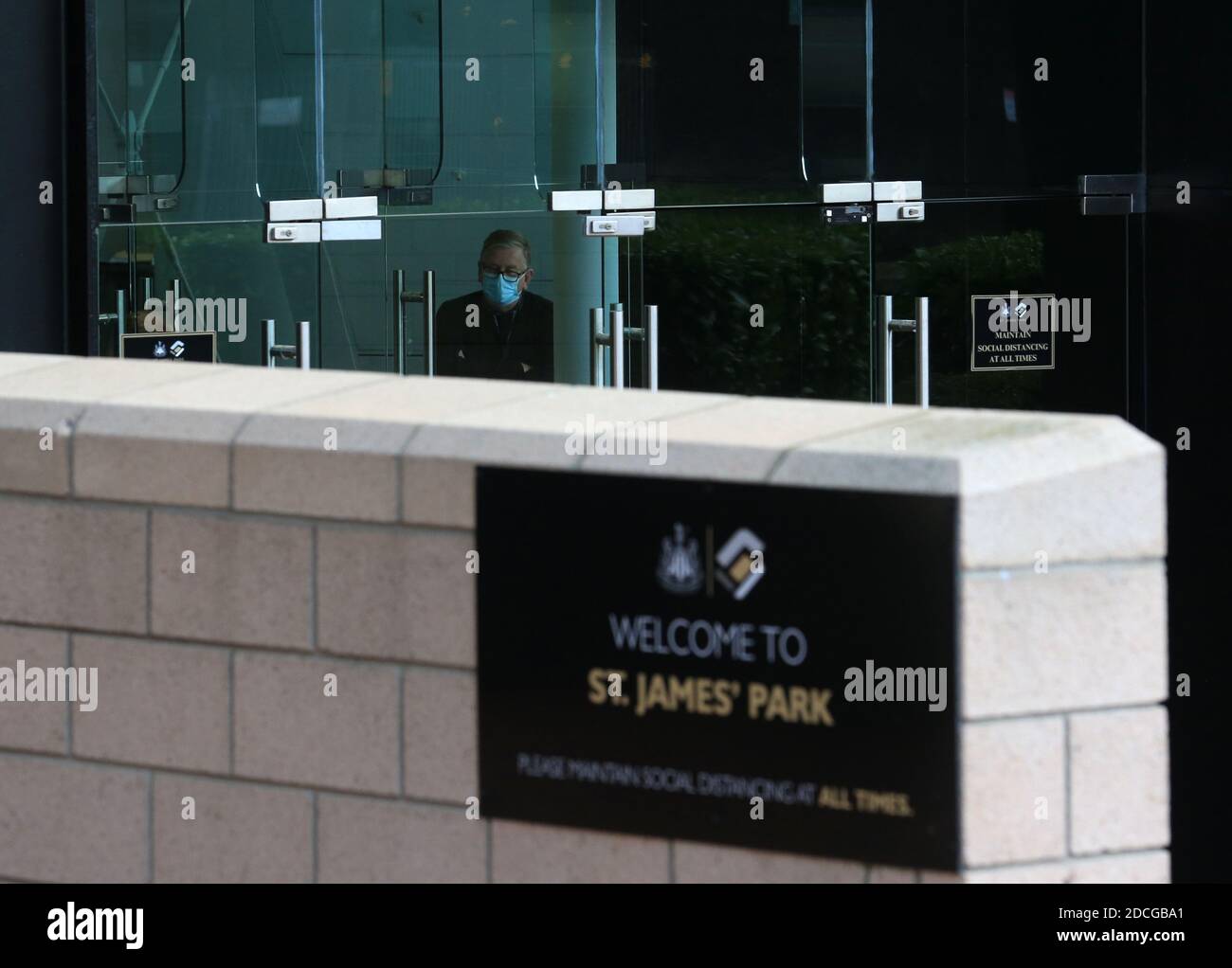 A door supervisor in PPE at the stadium entrance before the Premier League match at St James' Park, Newcastle. Stock Photo