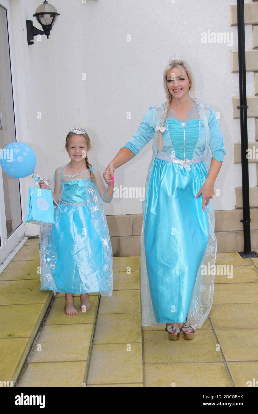 Costume fancy dress characters. Woman dressed as Elsa from frozen with a  little girls dressed as a princess Stock Photo - Alamy