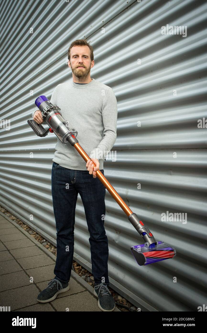 United Kingdom /Wiltshire/ Malmesbury/Dyson / industrial designer with vacuum cleaner. Stock Photo