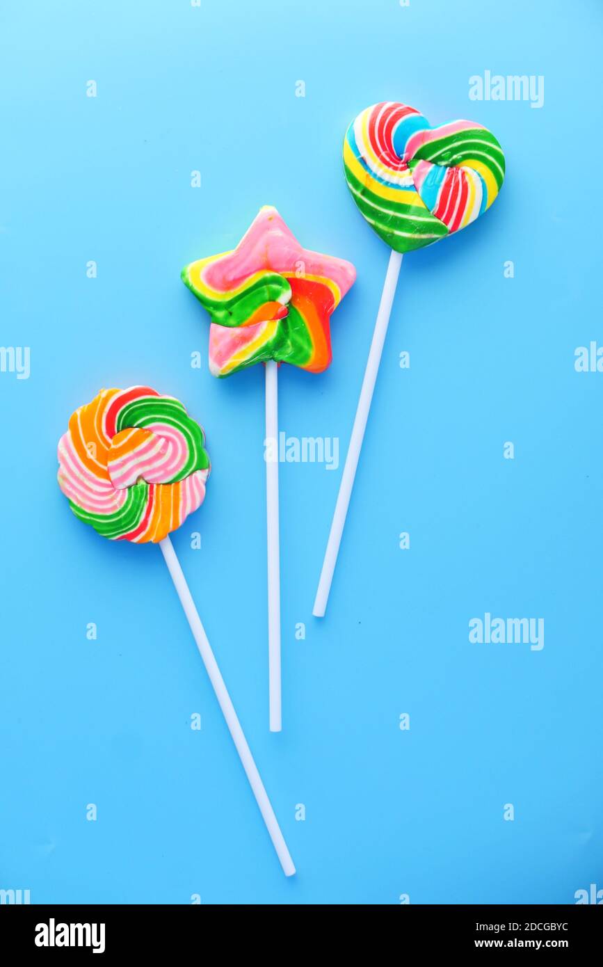 Top view of colorful lollipop on blue background, Stock Photo