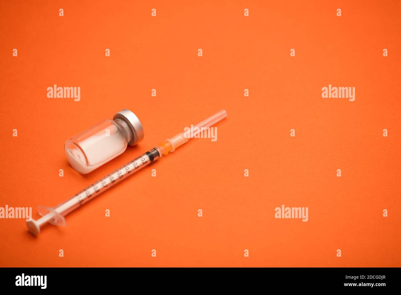 syringe with vaccine bottle, blue background Stock Photo - Alamy