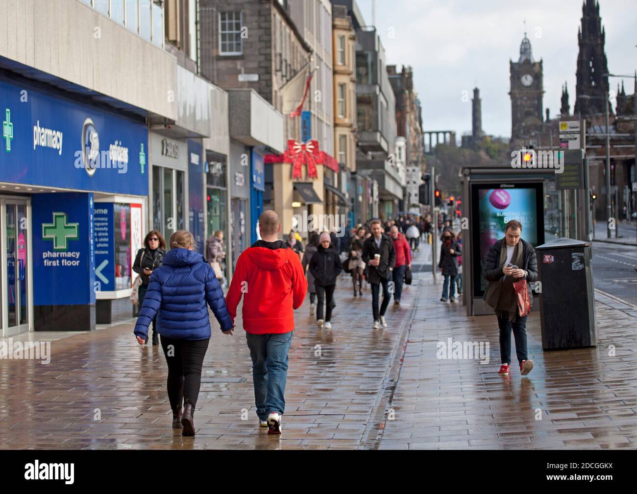 Princes Street and Calton Hill, Edinburgh, Scotland, UK. 21 November 2020. Sunshine and showers with blustery winds for those on a quiet Princes Street for a Saturday morning. Credit: Arch White/Alamy Live News. Stock Photo
