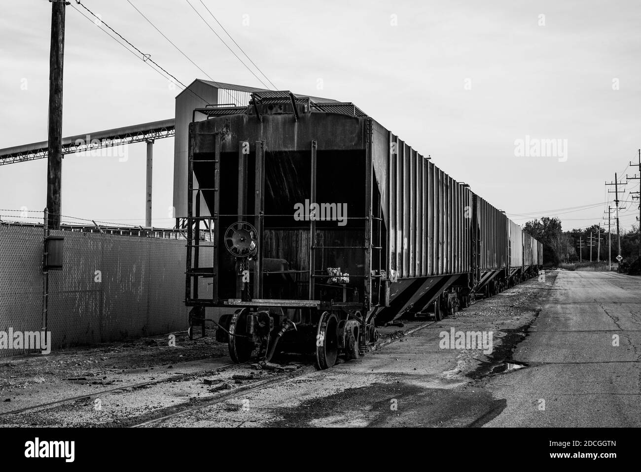 A small train and train cars sitting outside of the salt mines on Lake