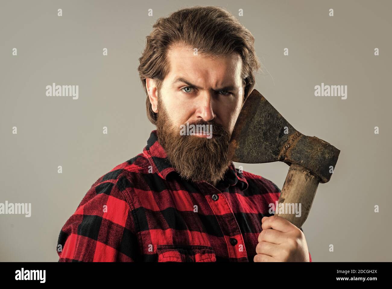 bearded man with axe. cut hair with ax. male hairdresser or barbershop ...