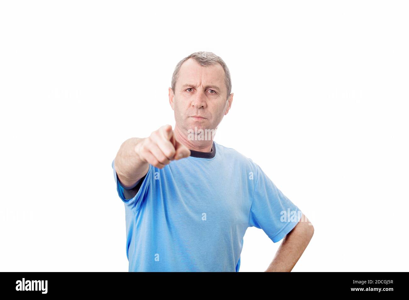 Angry young middle aged man pointing index finger showing to camera, like scolding someone, isolated over white background with copy space. Stock Photo