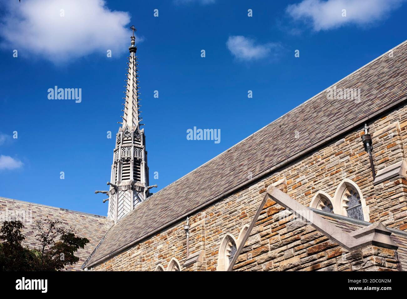 The steeple and exterior of the loyola alumni memorial chapel on the evergreen campus at Loyola University in Baltimore Maryland on a sunny blue sky d Stock Photo