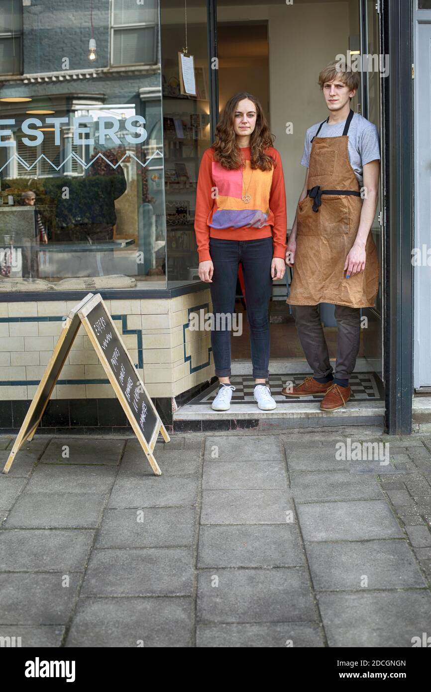 Great Britain / England / London /Happy young couple cafe owner in front of coffee shop in East London . Stock Photo
