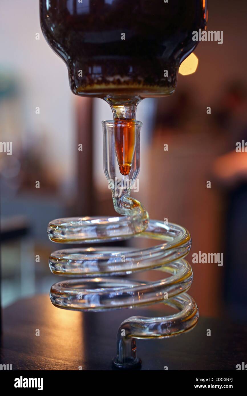 Great Britain / England / London /Coffee Style /Cold brew coffee driper.Close up of cold brew coffee flowing through glass coil of cold drip tower. Stock Photo
