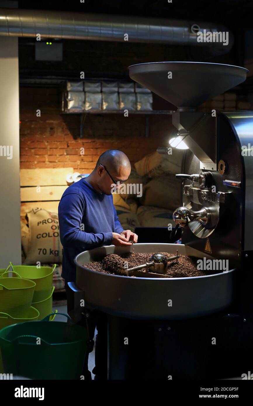 Great Britain / England / London Man holding roasted coffee beans , Man's hand holding coffee