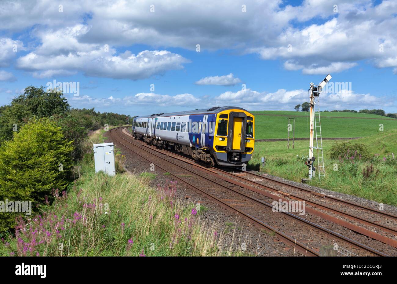 Northern Rail class 158 diesel train 158782  passing the semaphore signal at Hellifield, north Yorkshire Stock Photo