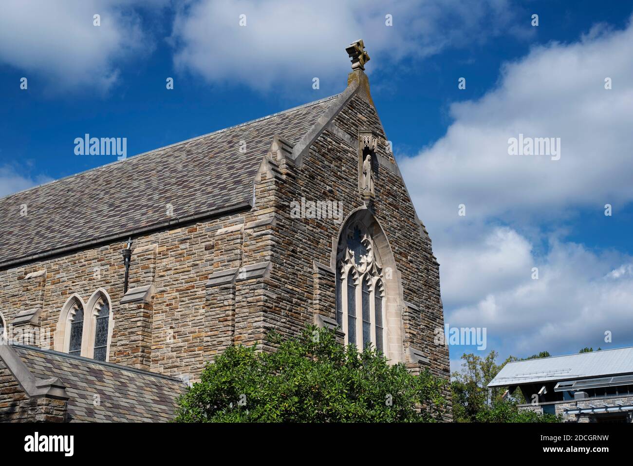 The front entrance and exterior of the loyola alumni memorial chapel on the evergreen campus at Loyola University in Baltimore Maryland on a sunny blu Stock Photo