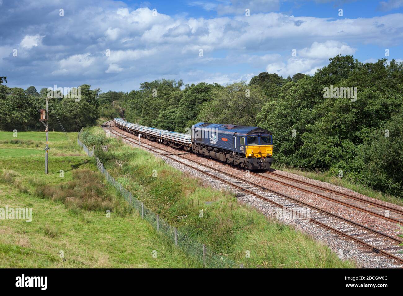 Direct rail Services class 66 locomotive on the Ribble valley railway line, Lancashire with freight train carrying materials for Network Rail Stock Photo