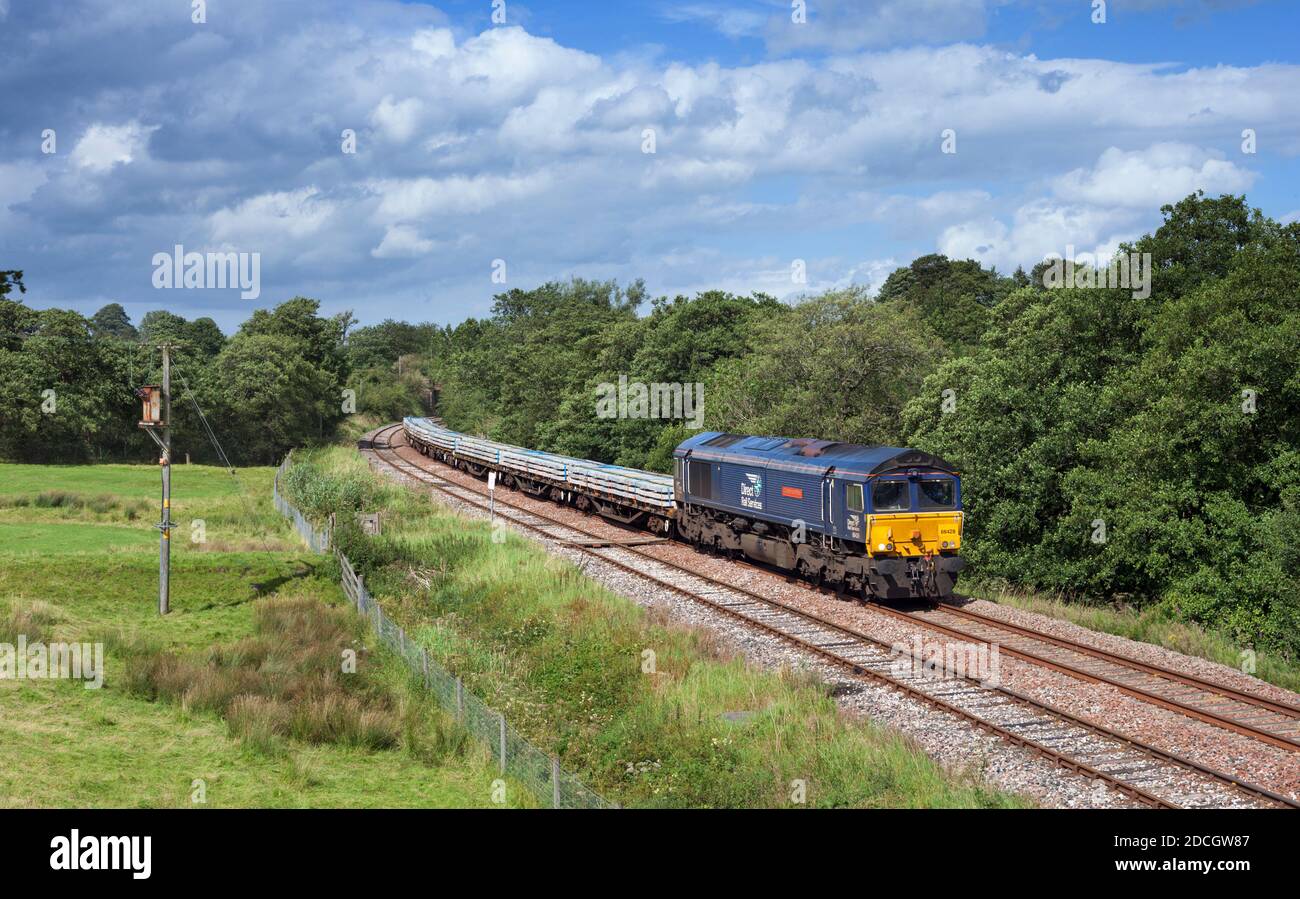 Direct rail Services class 66 locomotive on the Ribble valley railway line, Lancashire with freight train carrying materials for Network Rail Stock Photo