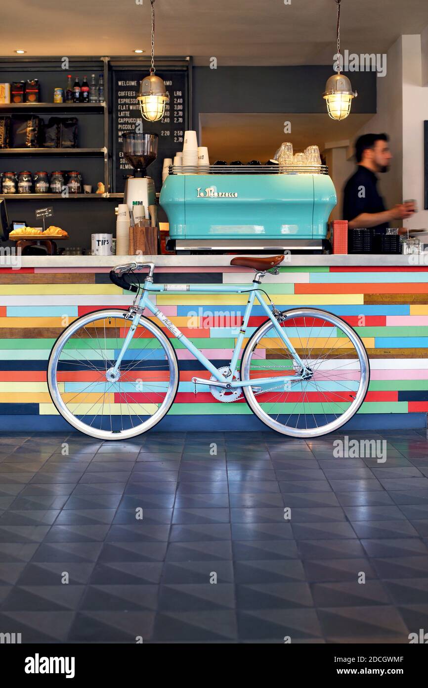 cool bicycle cafe ,bike vintage retro bike leaning next to espresso machine , London , UK Stock Photo