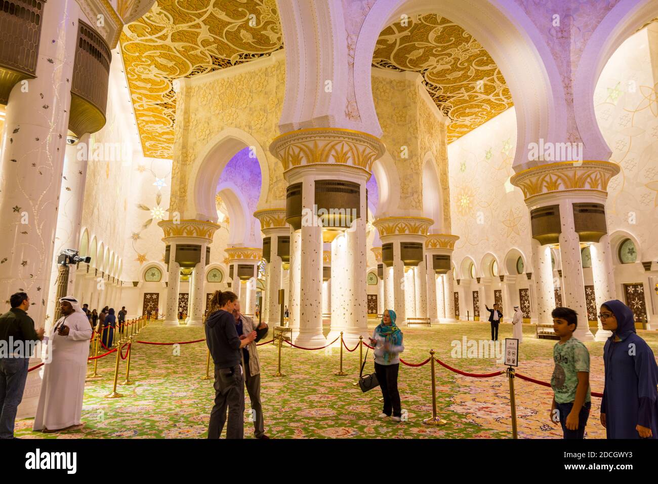 A lot of tourists inside of the Grand Mosque in Abu-Dhabi, UAE, also called Sheikh Zayed Grand Mosque, inspired by Persian, Mughal and Moorish mosque Stock Photo