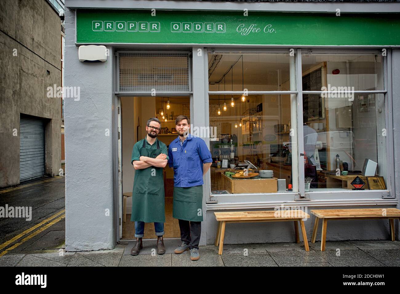 Ireland/Dublin /Coffee Style /Young owners of Proper Order Coffee Co. standing arms crossed In front of the cafe Stock Photo