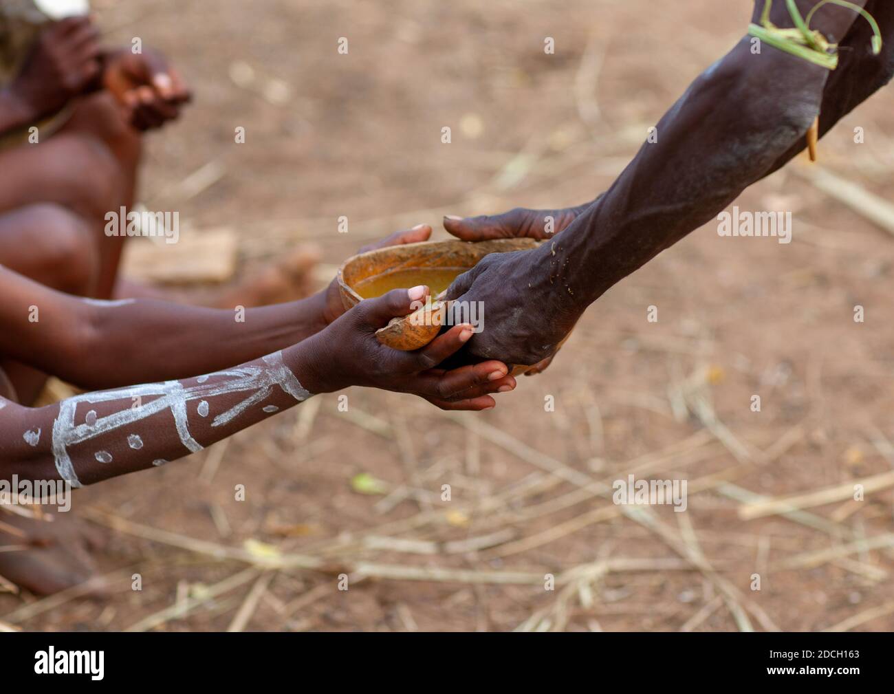 Tharaka tribe people drinking alcohol in a calabash, Laikipia County